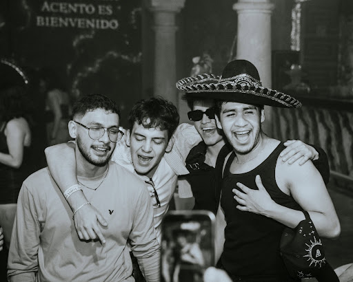 Friends celebrating in sombreros with ecstatic smiles
